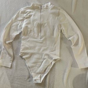 Set of white and black ribbed 1/4 zip bodysuits